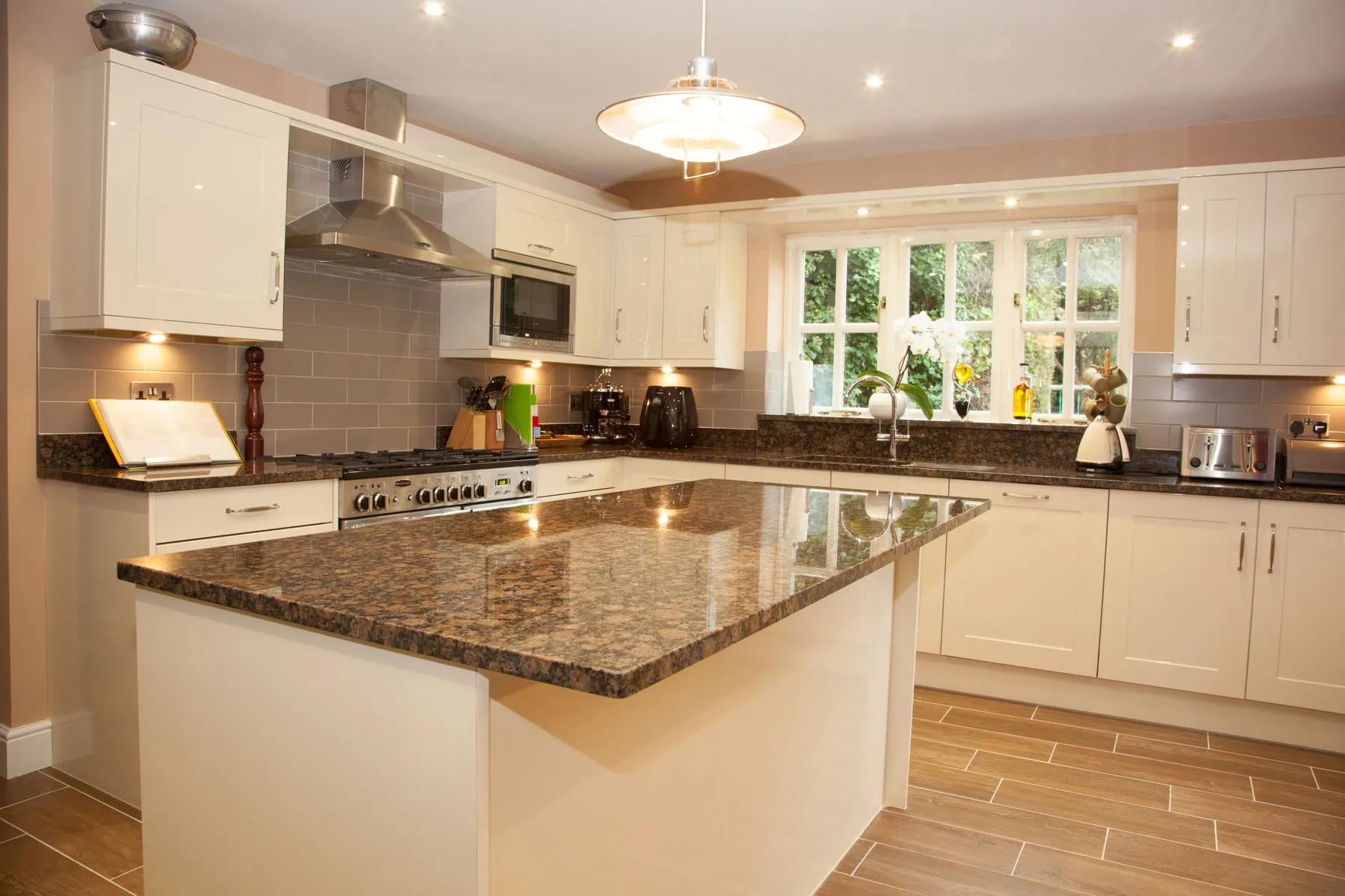 A kitchen with an island designed and installed by Aspire Kitchens